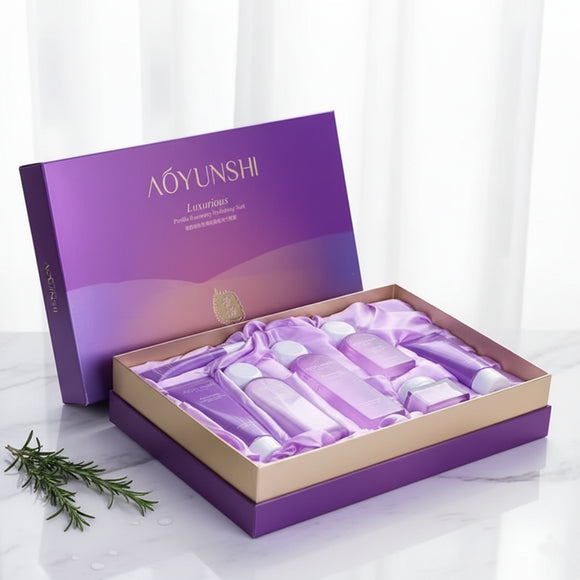 AOYUNSHI Luxurious Perilla Rosemary Hydrating Suit 7 Piece Set in open purple box packaging. The set includes seven purple and white bottles/tubes for a complete daily routine: Cleanser, Essence Water (Toner), Essence Lotion, Eye Cream, Essence Cream, and two BB Creams. Focus on Perilla and Rosemary extracts for moisturizing and soothing skin. Barcode: 6942349704079